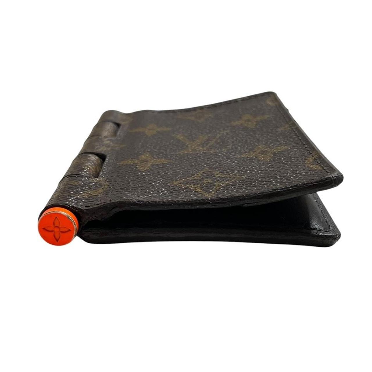 Louis Vuitton brown purse with orange metal hardware and iconic monogram pattern.
