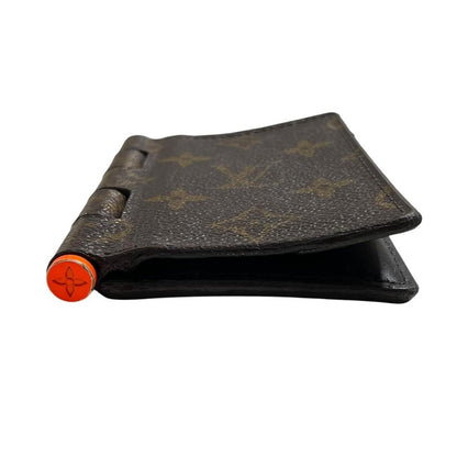 Louis Vuitton brown purse with orange metal hardware and iconic monogram pattern.