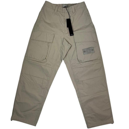 Stone Island beige cargo trousers with logo patch and multiple pockets.