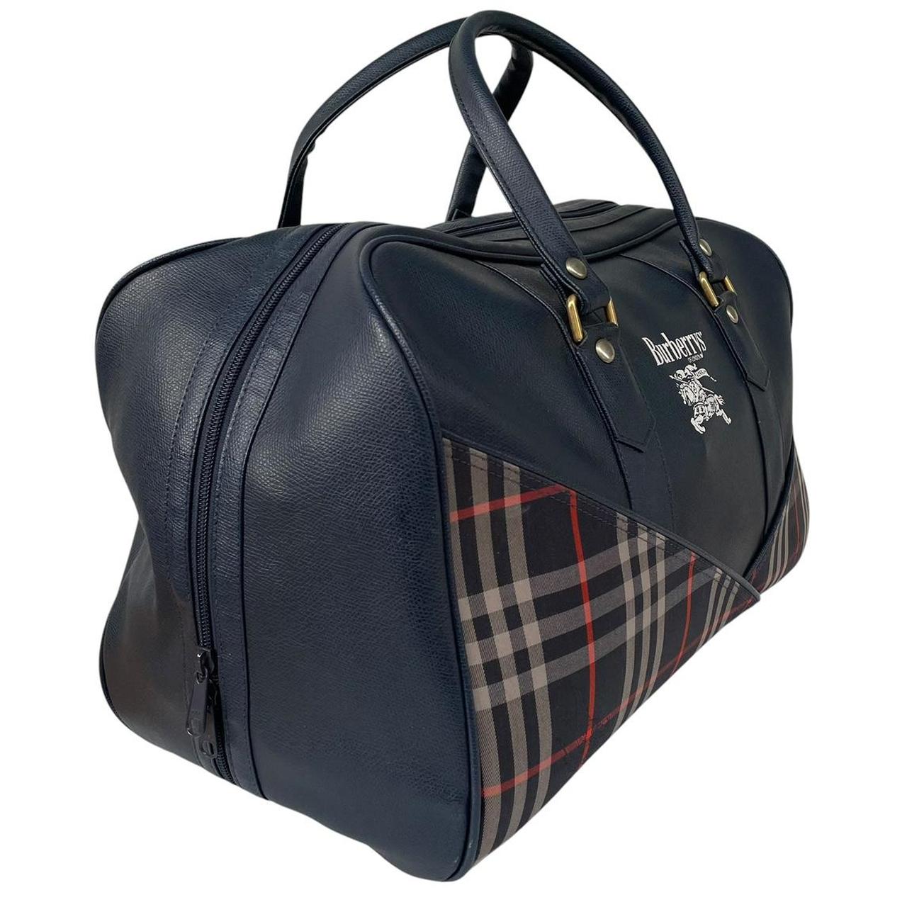 Burberry navy blue duffel bag featuring iconic Nova Check pattern and leather accents.
