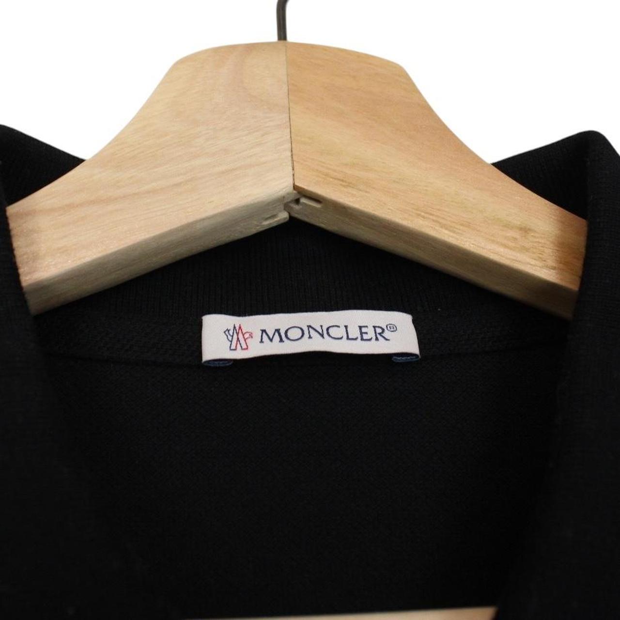 Moncler black short sleeve polo shirt with embroidered logo and cotton material.