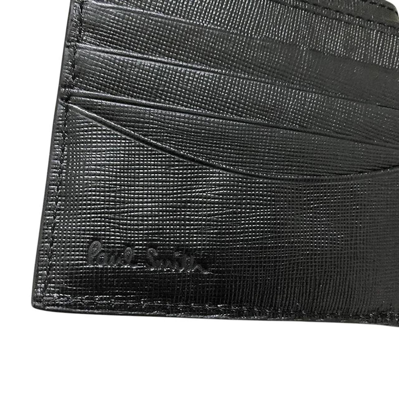 Paul Smith black bifold wallet textured crosshatch leather with logo detail.