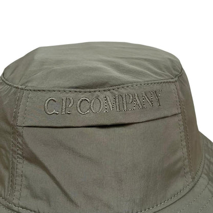 CP Company green bucket hat embroidered logo, made from Chrome-R nylon material.