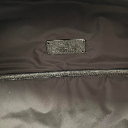 Moncler black duffel bag with logo patch and durable material, pre-loved condition.