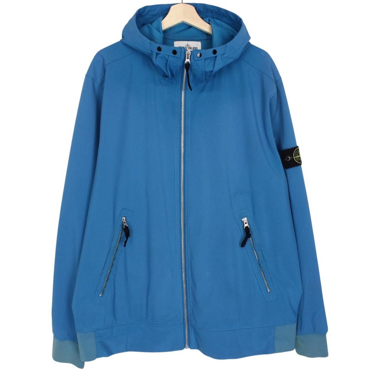 Stone Island blue full zip jacket with logo patch and soft shell material.