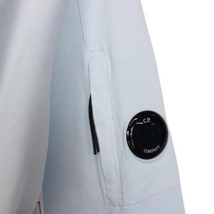 CP Company light blue sweatshirt with signature lens detail and cotton fabric.