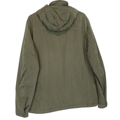 CP Company green hooded jacket with chrome detailing and logo patch on sleeve.