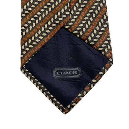 Coach brown floral print silk tie with intricate flower patterns and smooth texture.