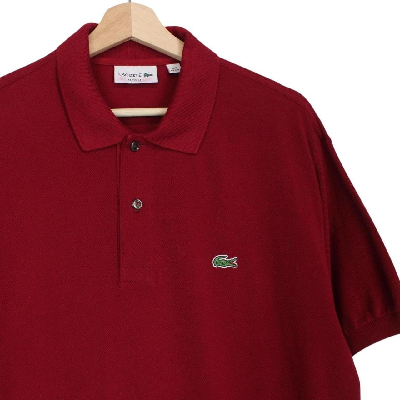 Lacoste burgundy polo shirt with embroidered crocodile logo and pocket detail.