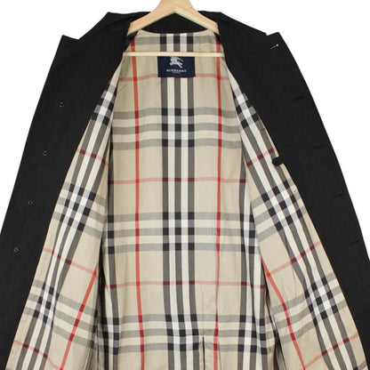 Burberry black Balmacaan coat with Nova Check lining and logo detail.