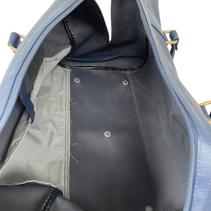 Burberry navy blue duffel bag featuring iconic Nova Check pattern and leather accents.