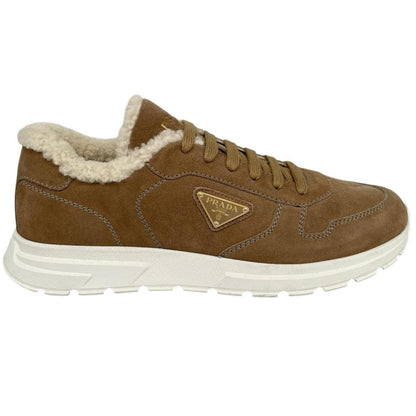Prada brown suede trainers with shearling lining and logo detail.