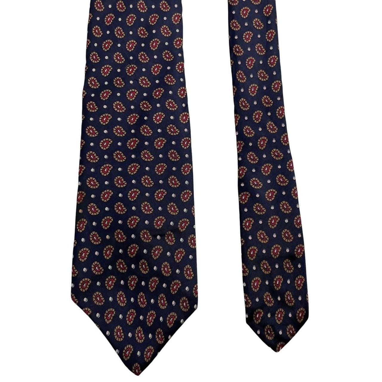 Christian Dior navy blue silk tie with paisley print pattern and logo detail.