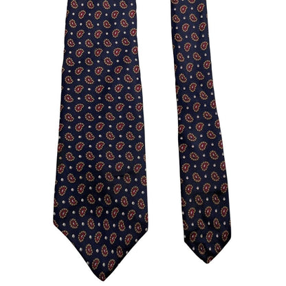 Christian Dior navy blue silk tie with paisley print pattern and logo detail.