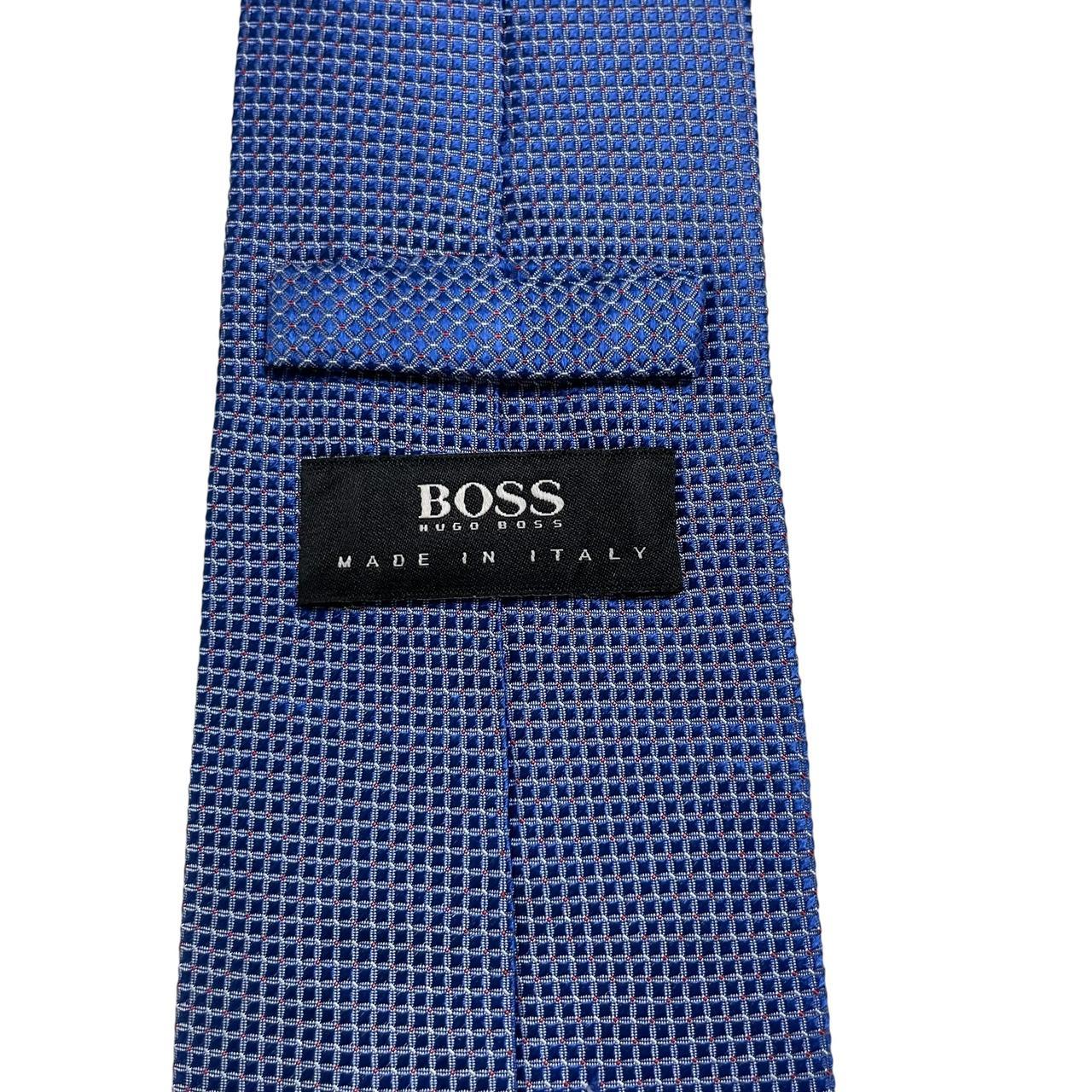 Hugo Boss blue silk tie with smooth texture and subtle sheen.