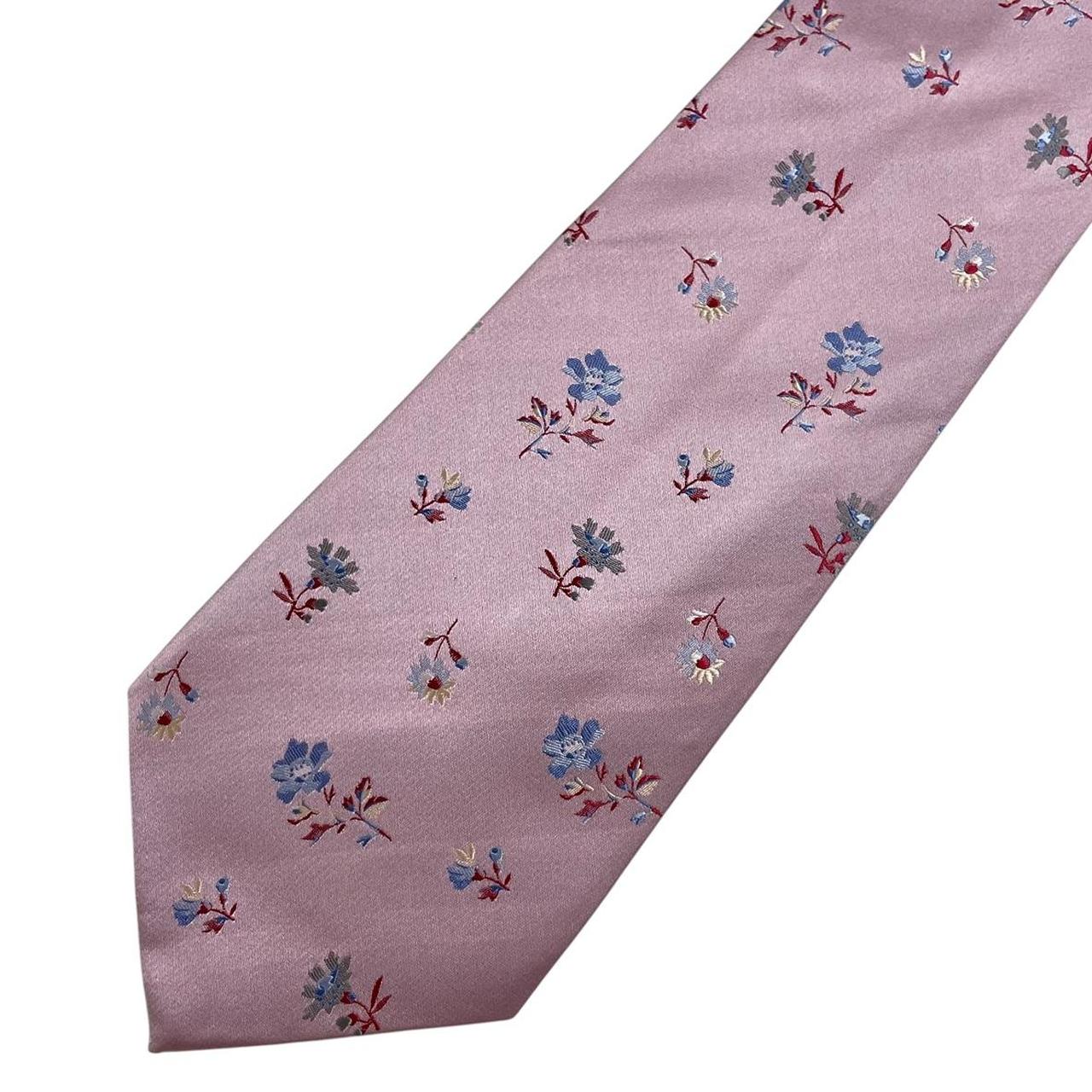 Paul Smith pink silk tie with floral embroidery and signature logo detail.