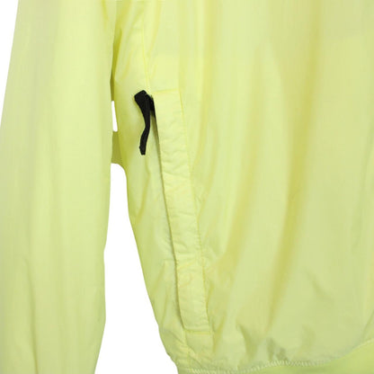 Stone Island yellow jacket with crinkle texture and logo badge on sleeve.