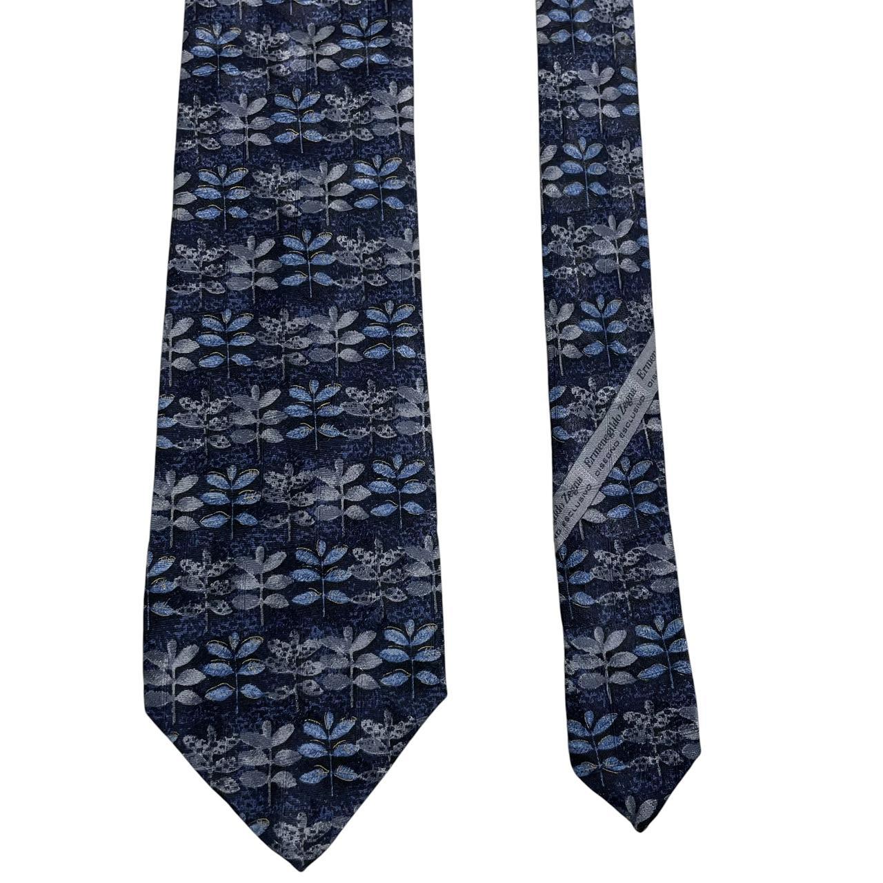 Ermenegildo Zegna blue silk tie with floral print design and logo detail.