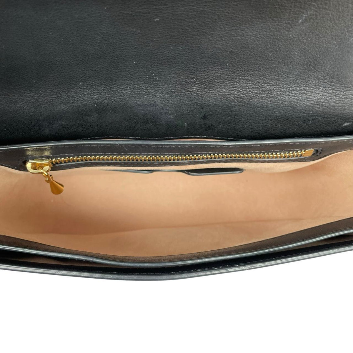 Alexander McQueen black and gold leather messenger bag with logo detailing and faint scratches.