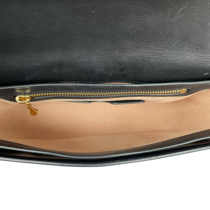 Alexander McQueen black and gold leather messenger bag with logo detailing and faint scratches.