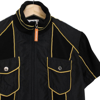 Christian Dior black and yellow jacket with 'Remove Before Flight' graphic detail.
