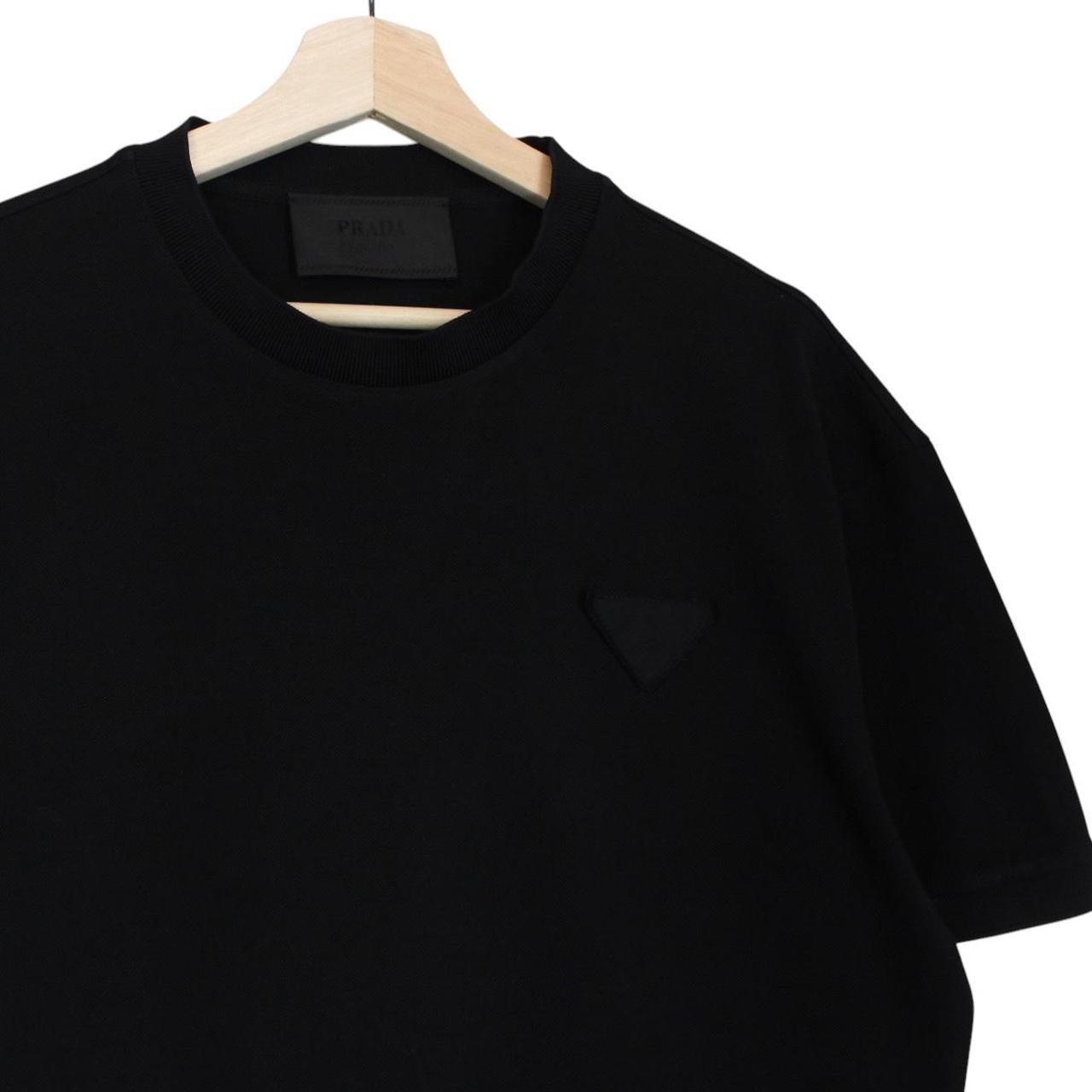 Prada black and white cotton short sleeve t-shirt with logo pocket detail.