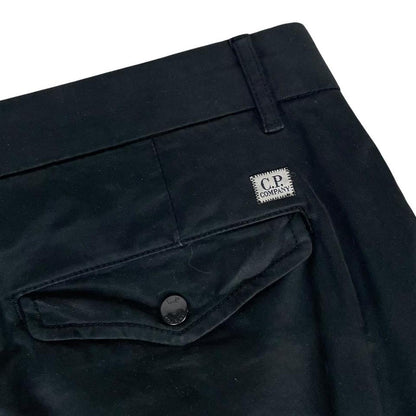 CP Company navy blue tapered fit cargo trousers with lens detail and pockets.
