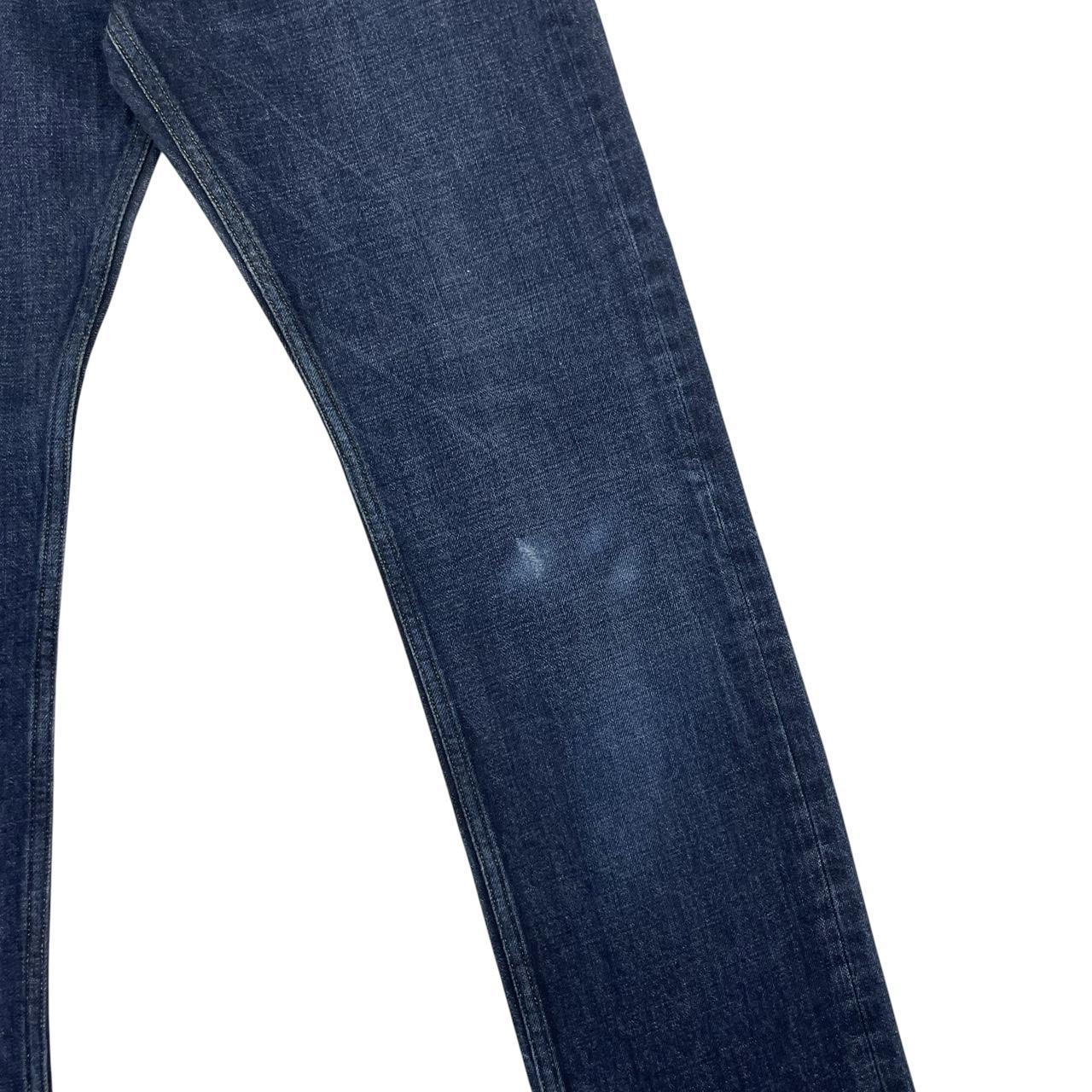 Stone Island navy blue straight jeans with logo patch and visible scuff on left knee.