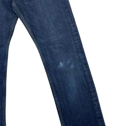 Stone Island navy blue straight jeans with logo patch and visible scuff on left knee.