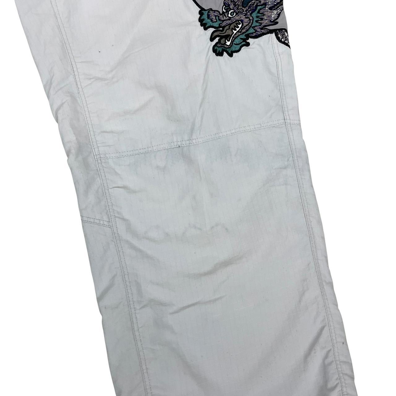 Palace grey joggers embroidered dragon design, made of nylon, size medium.