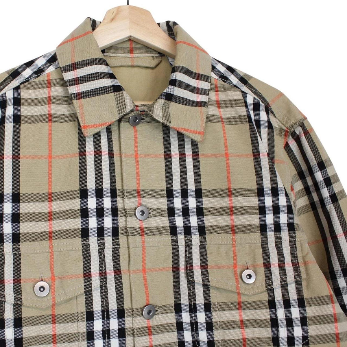 Burberry beige denim jacket featuring iconic Nova Check pattern and logo detail.
