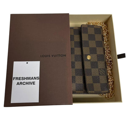 Louis Vuitton gold crossbody wallet Damier Ebene canvas with removable strap and logo.