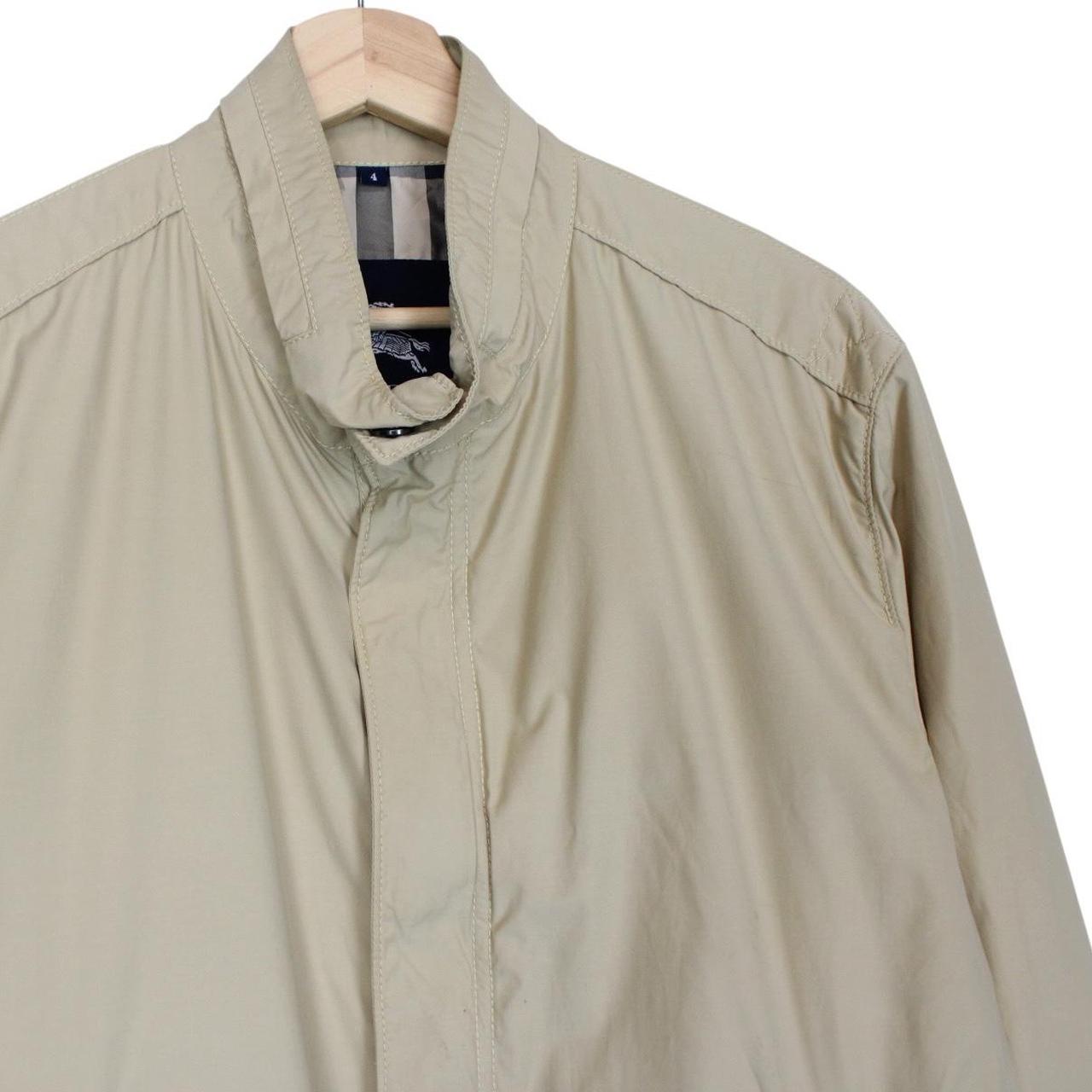 Burberry beige windbreaker jacket with full zip, logo detail, and nylon material.