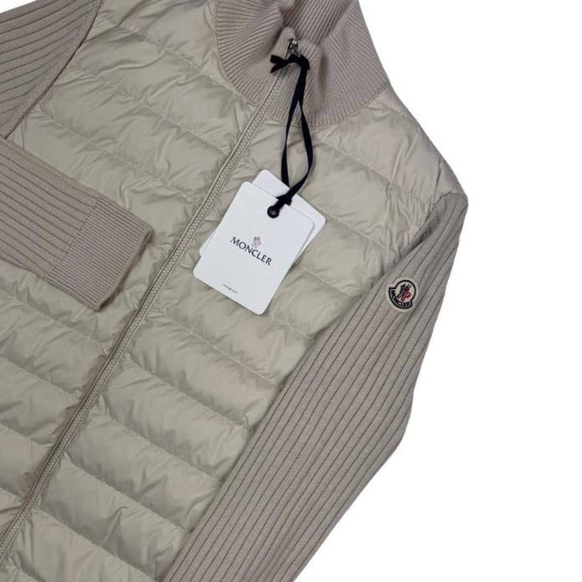 Moncler beige full zip jacket with logo detail and nylon/wool blend material.