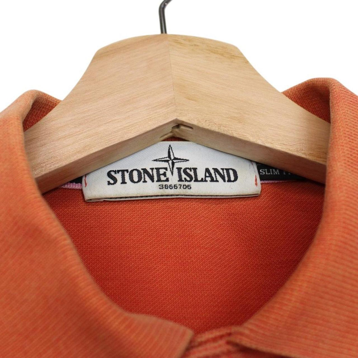 Stone Island orange short sleeve polo shirt with compass logo and cotton material.