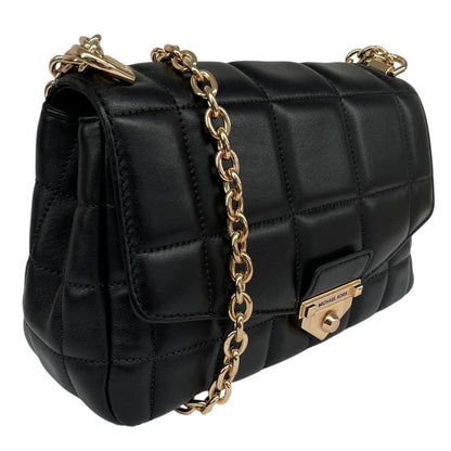 Michael Kors black duffel bag with quilted pattern and logo detail, pre-loved condition.
