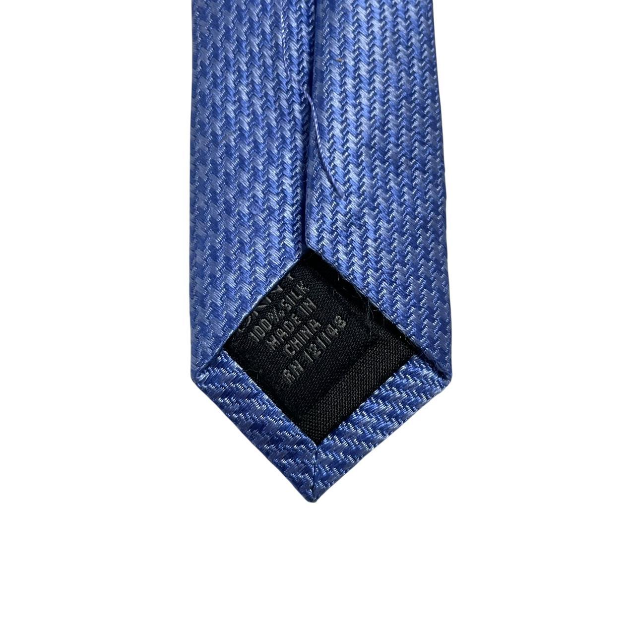 DKNY blue silk tie with subtle sheen and classic design.