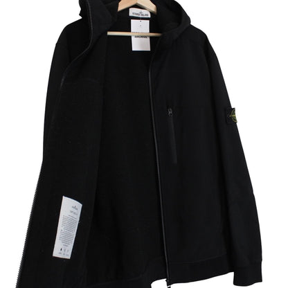 Stone Island black soft shell jacket with full zip and iconic compass logo.