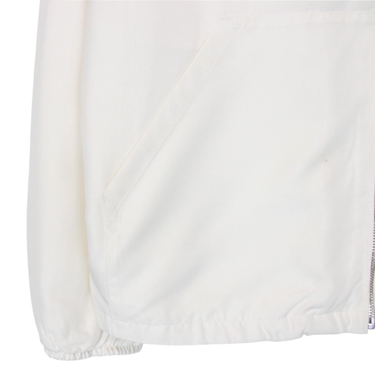 Prada cream silk hooded jacket with triangle logo and full zip detail.