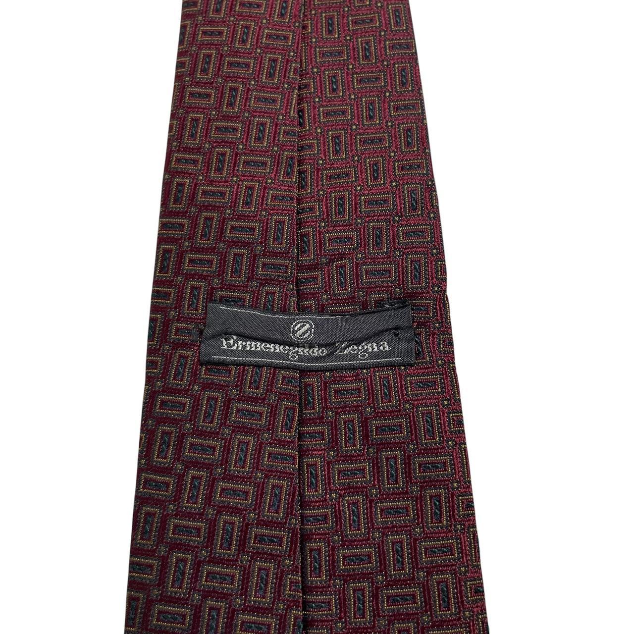 Ermenegildo Zegna burgundy silk tie with geometric print design and logo detail.