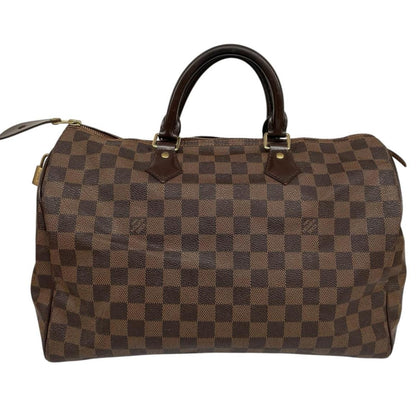 Louis Vuitton brown Damier Ebene canvas Speedy 35 bag with logo and gold-tone hardware.