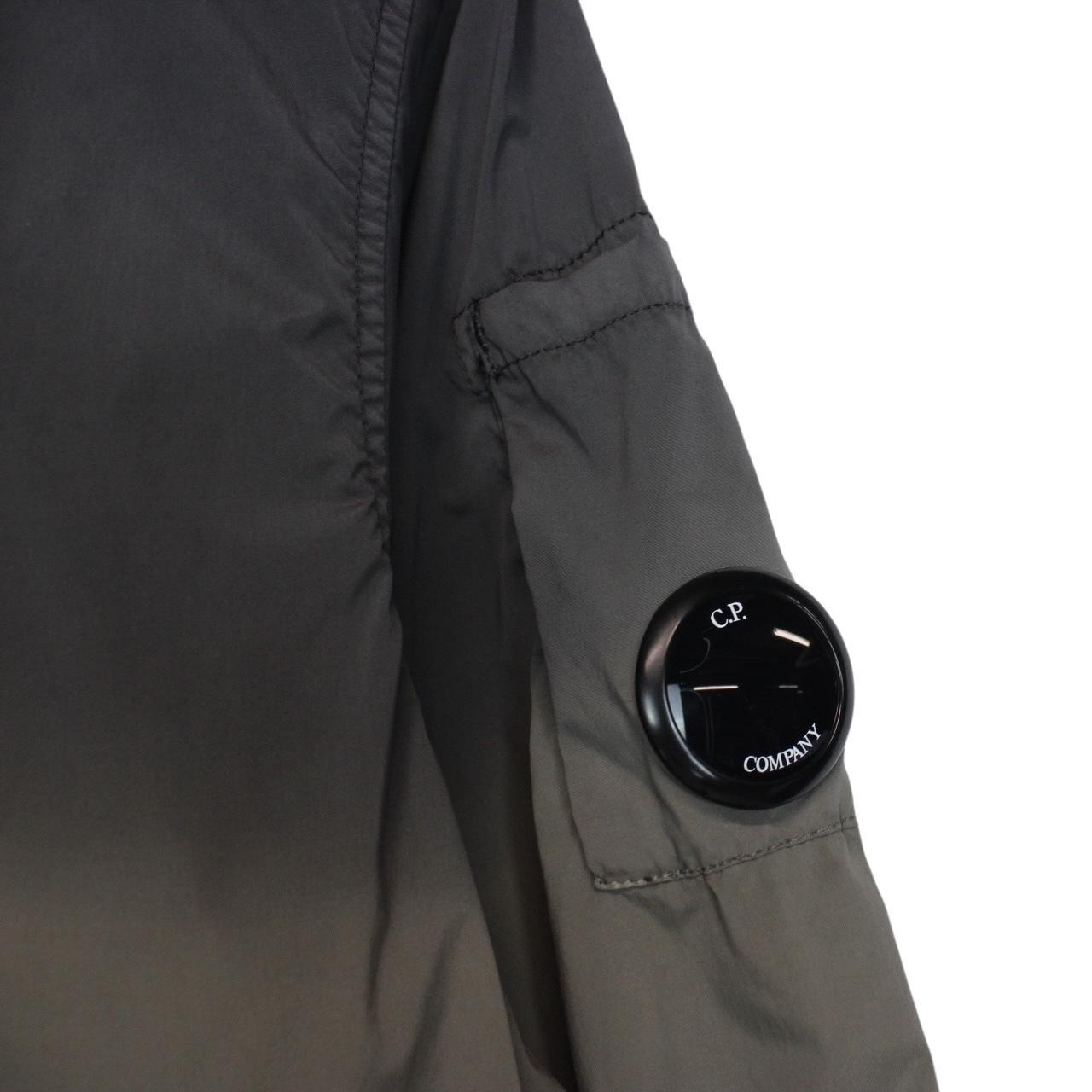 CP Company khaki green and grey jacket with shibori pattern and lens detail.