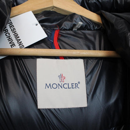 Moncler navy blue hooded nylon down gilet with logo and quilted texture.