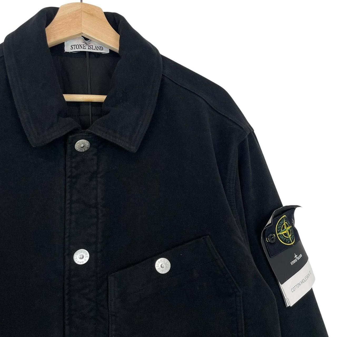 Stone Island navy blue work jacket with detachable compass badge and button-down closure.