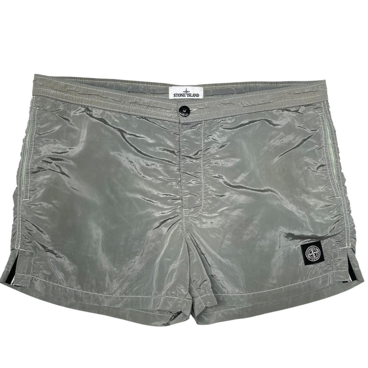Stone Island green swim shorts with logo patch and nylon metal material.