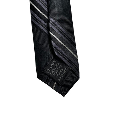 DKNY black silk tie with vintage striped pattern and logo detail.