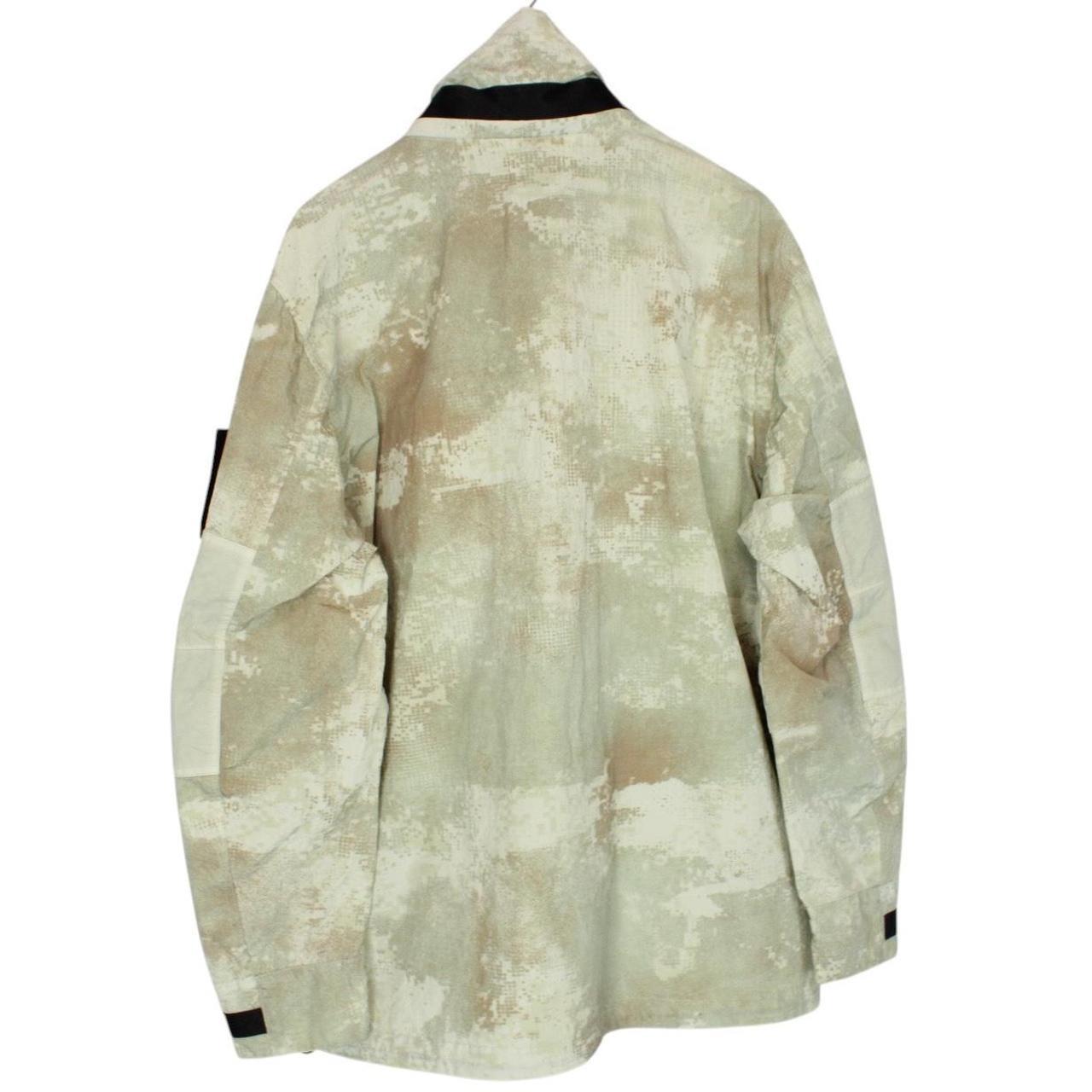 Stone Island green full zip jacket with dissolving grid camo pattern and logo patch.