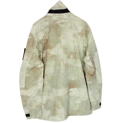 Stone Island green full zip jacket with dissolving grid camo pattern and logo patch.