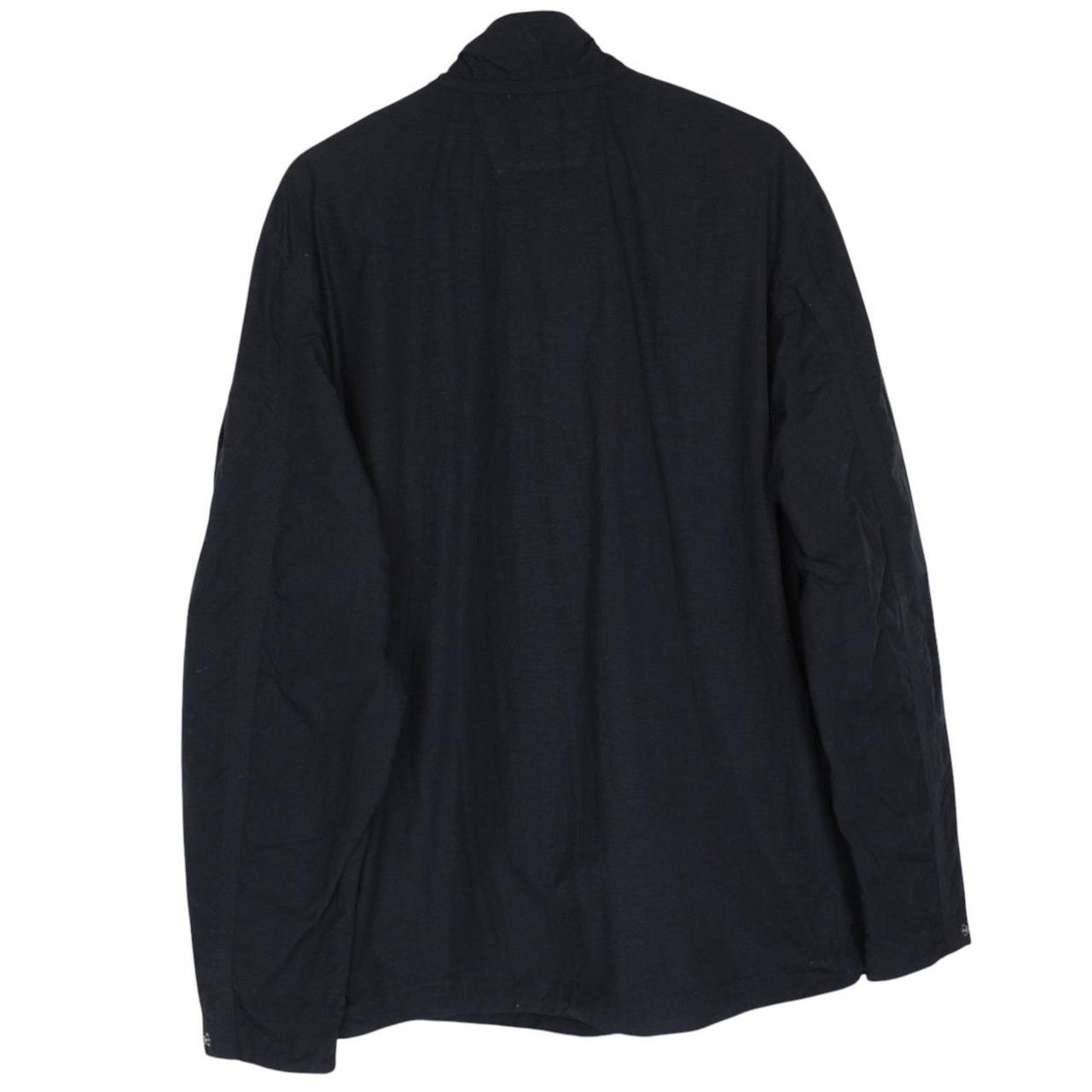 CP Company navy blue jacket 1/4 zip with lens detail and flat nylon material.