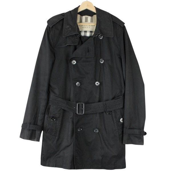 Burberry black trench coat featuring Nova Check pattern, double-breasted design, and belted waist.